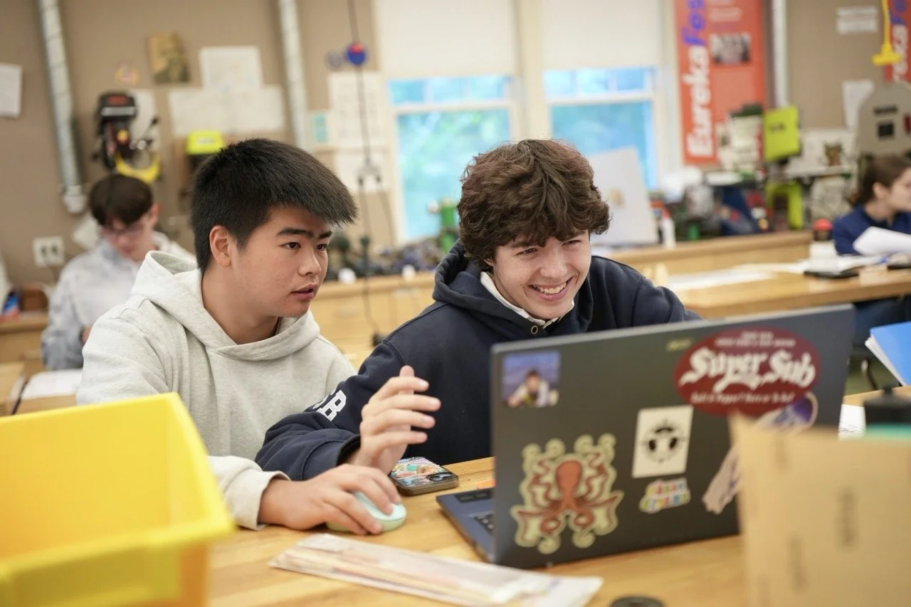 2 students with laptop